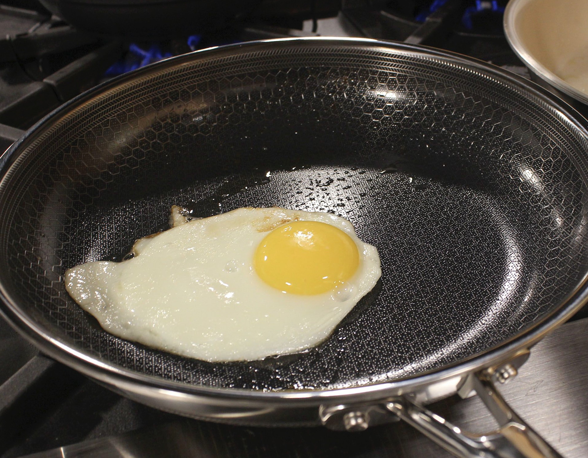 Sizzling egg on frying pan interaction.